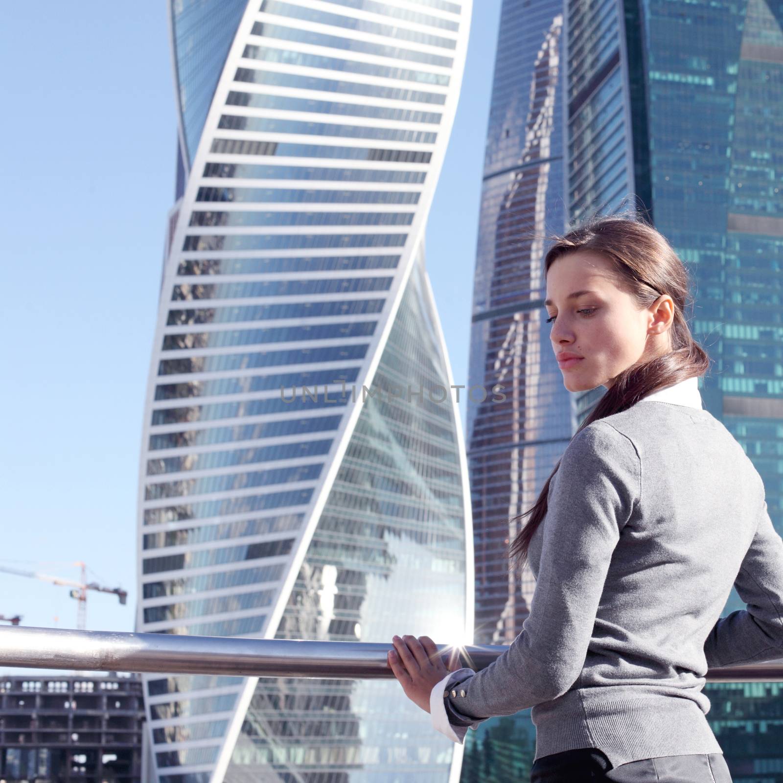 Businesswoman at skyscraper background by ALotOfPeople