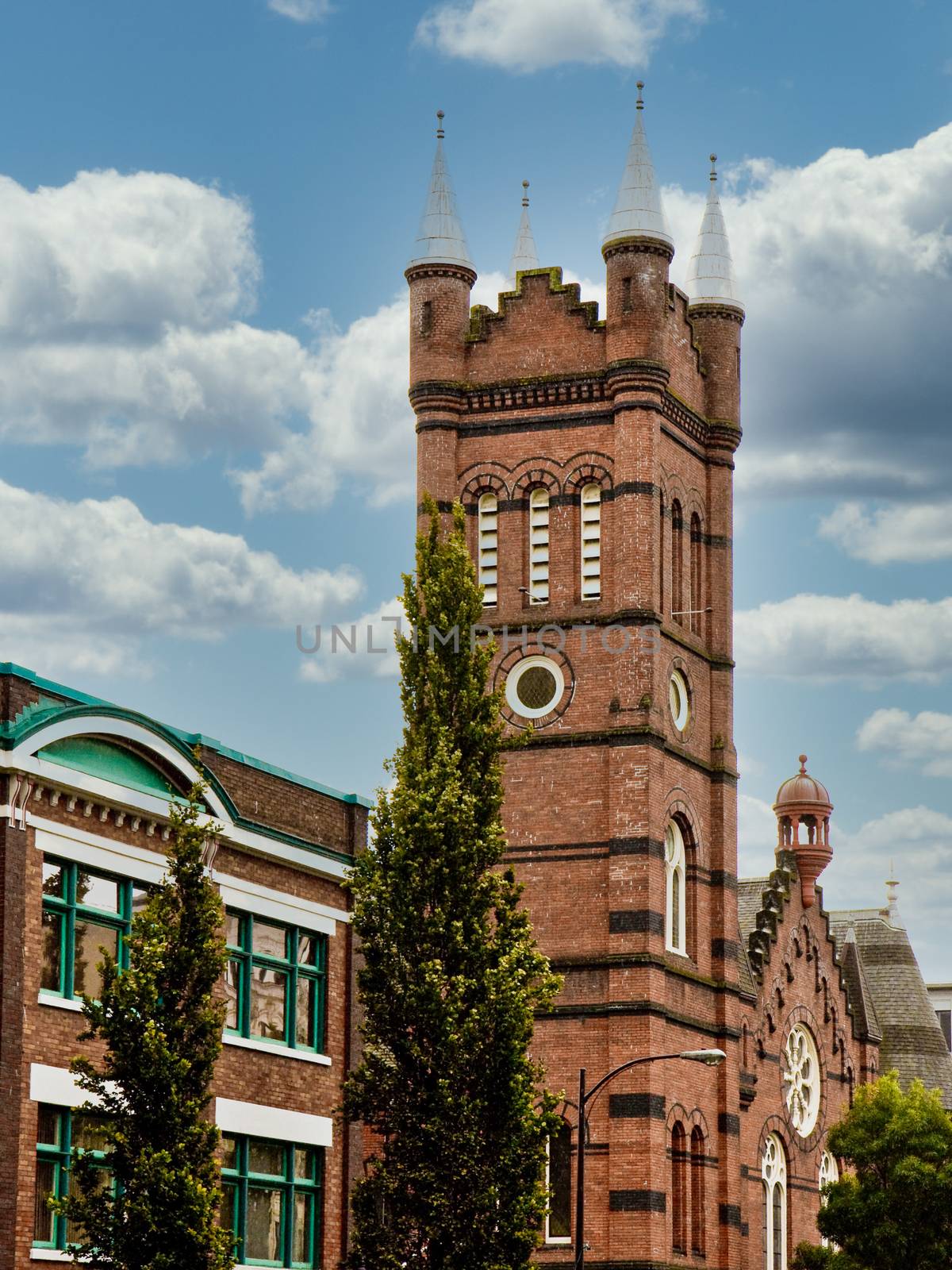 An old classic brick church tower on a blue background