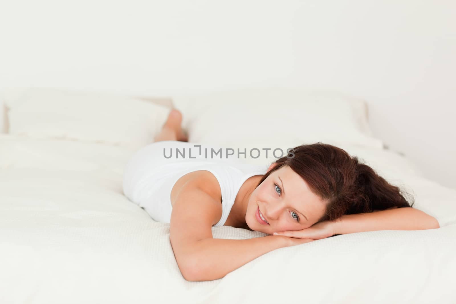 Portrait of a Cute woman looking into the camera in her bedroom