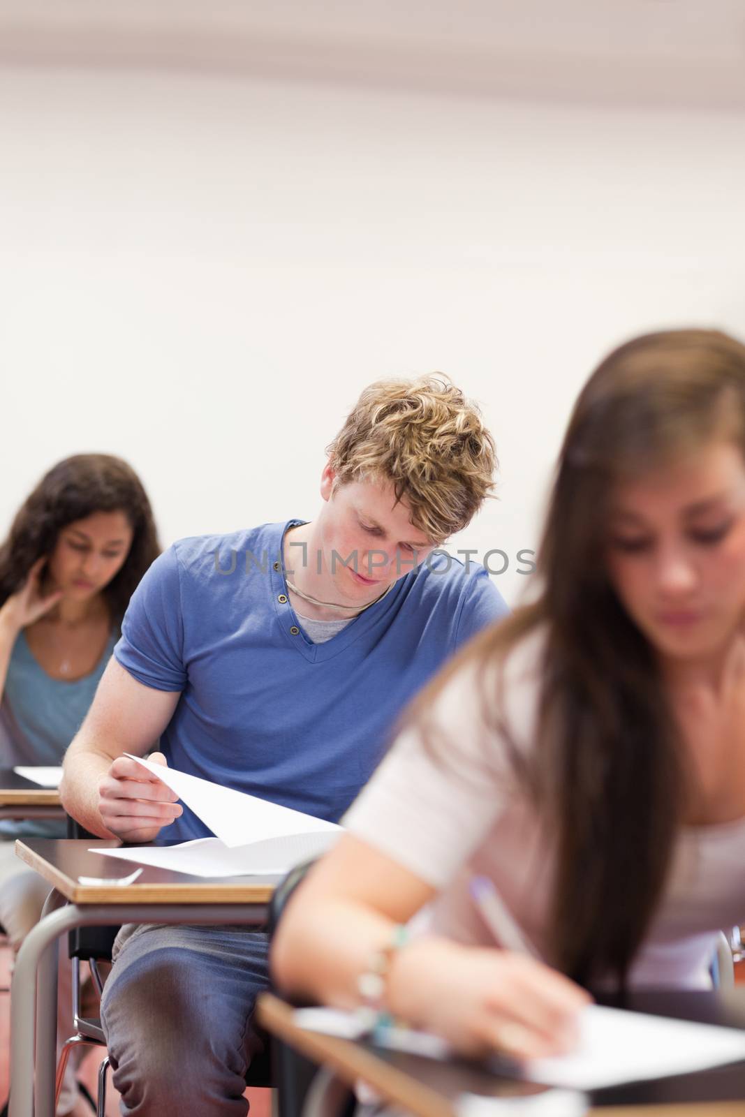 Portrait of young students doing an assignment in a classroom