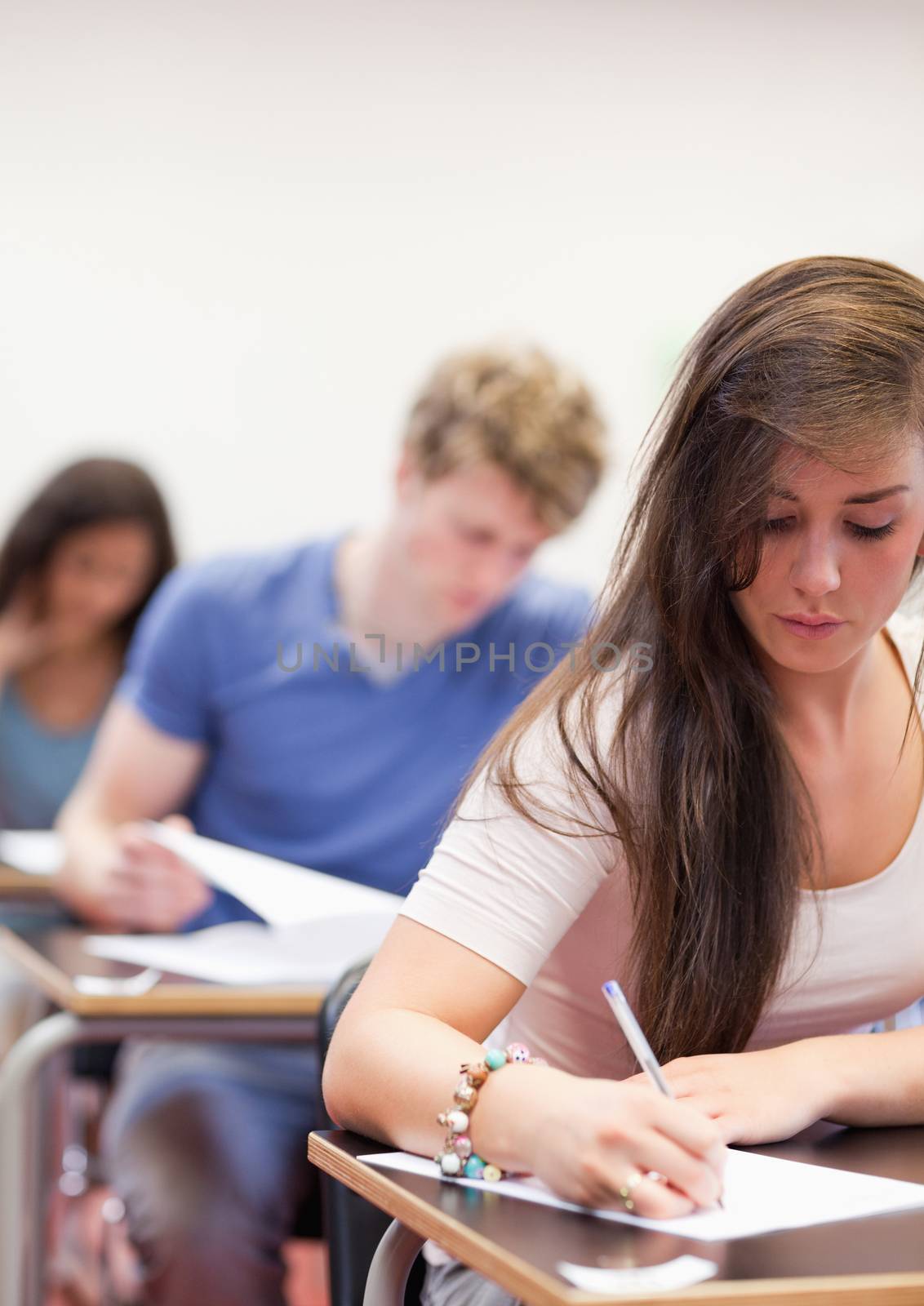 Portrait of students having a test in a classroom