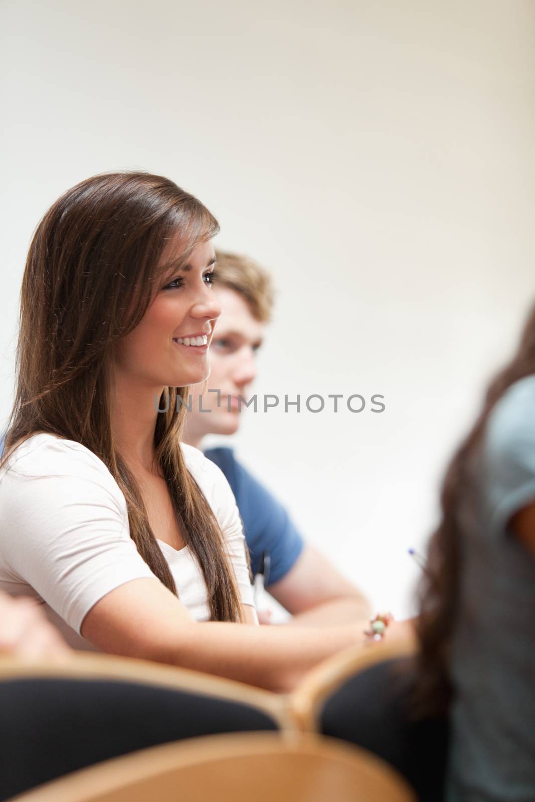 Portrait of a smiling student sitting in an amphitheater