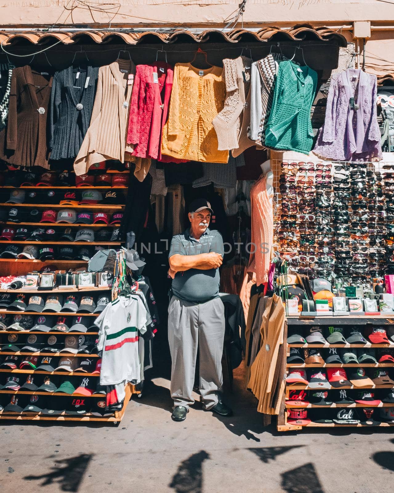 A middle age Turkish man standing in front of a clothing store.This image was taken on May 2014, at Ankara , Turkey.