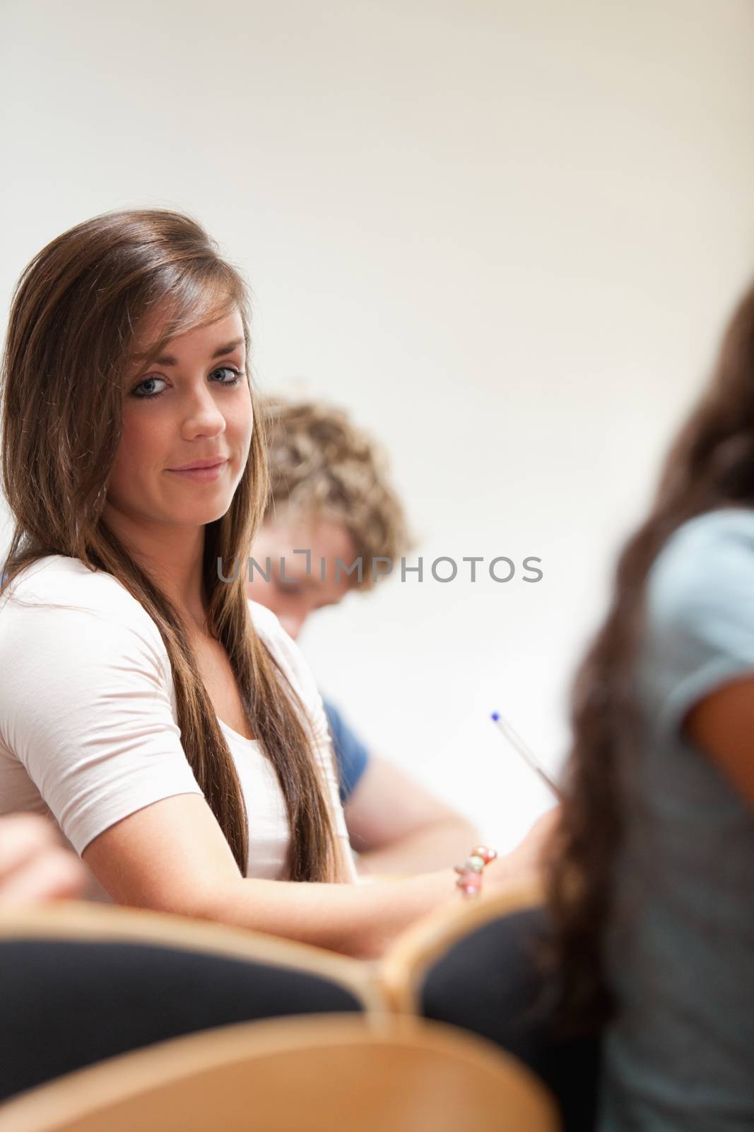 Portrait of a distracted student sitting in an amphitheater