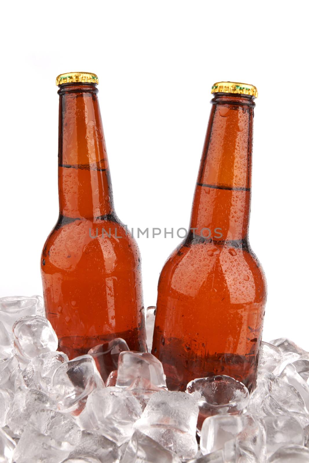 Two bottles of beer on ice isolated on white background