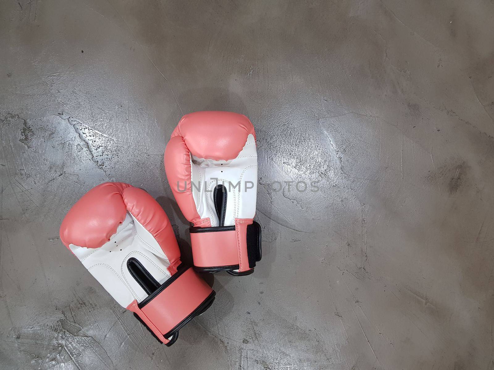 One pair of boxing gloves in red & white color.