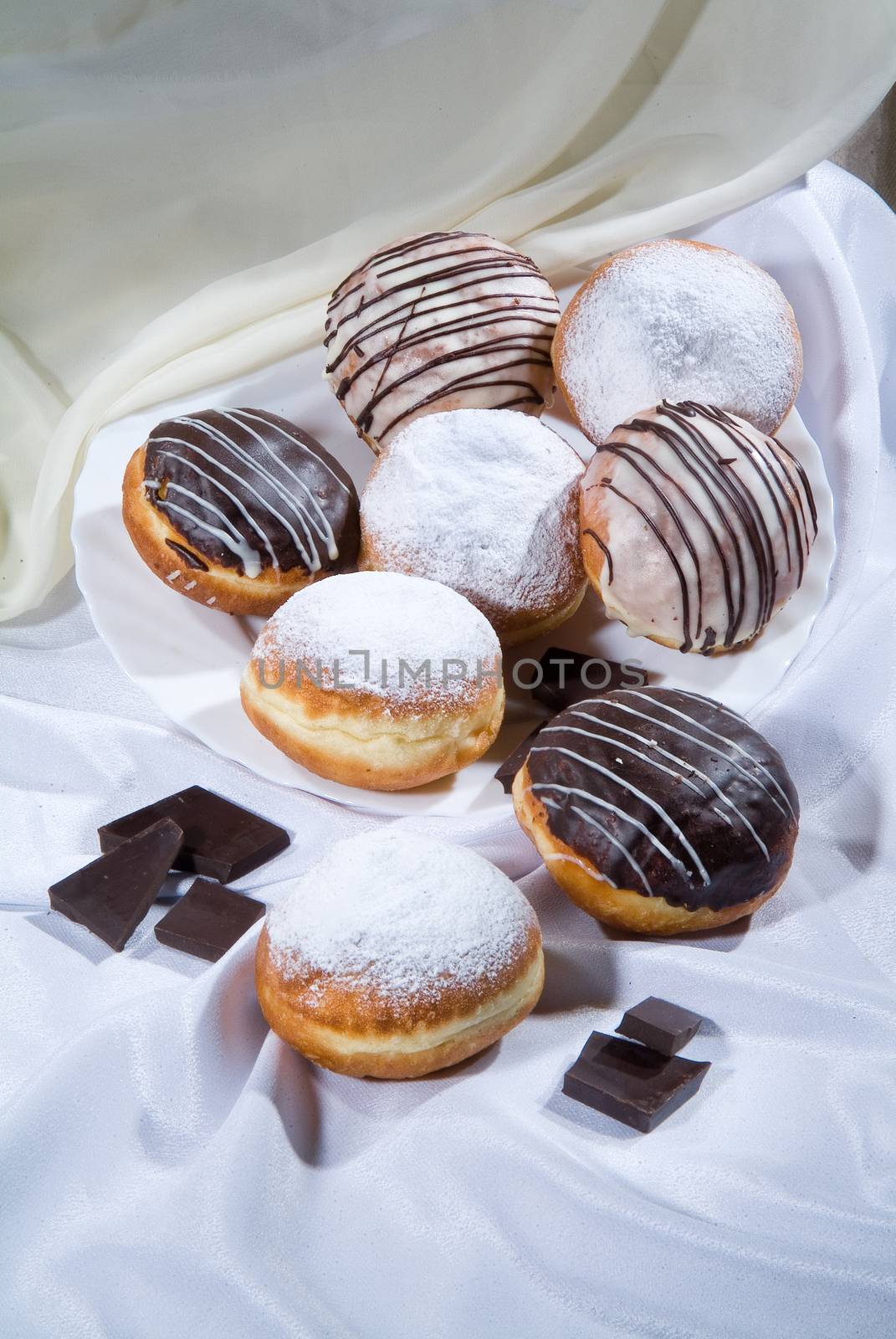Different kinds of bread and pastry on a canvas studio background