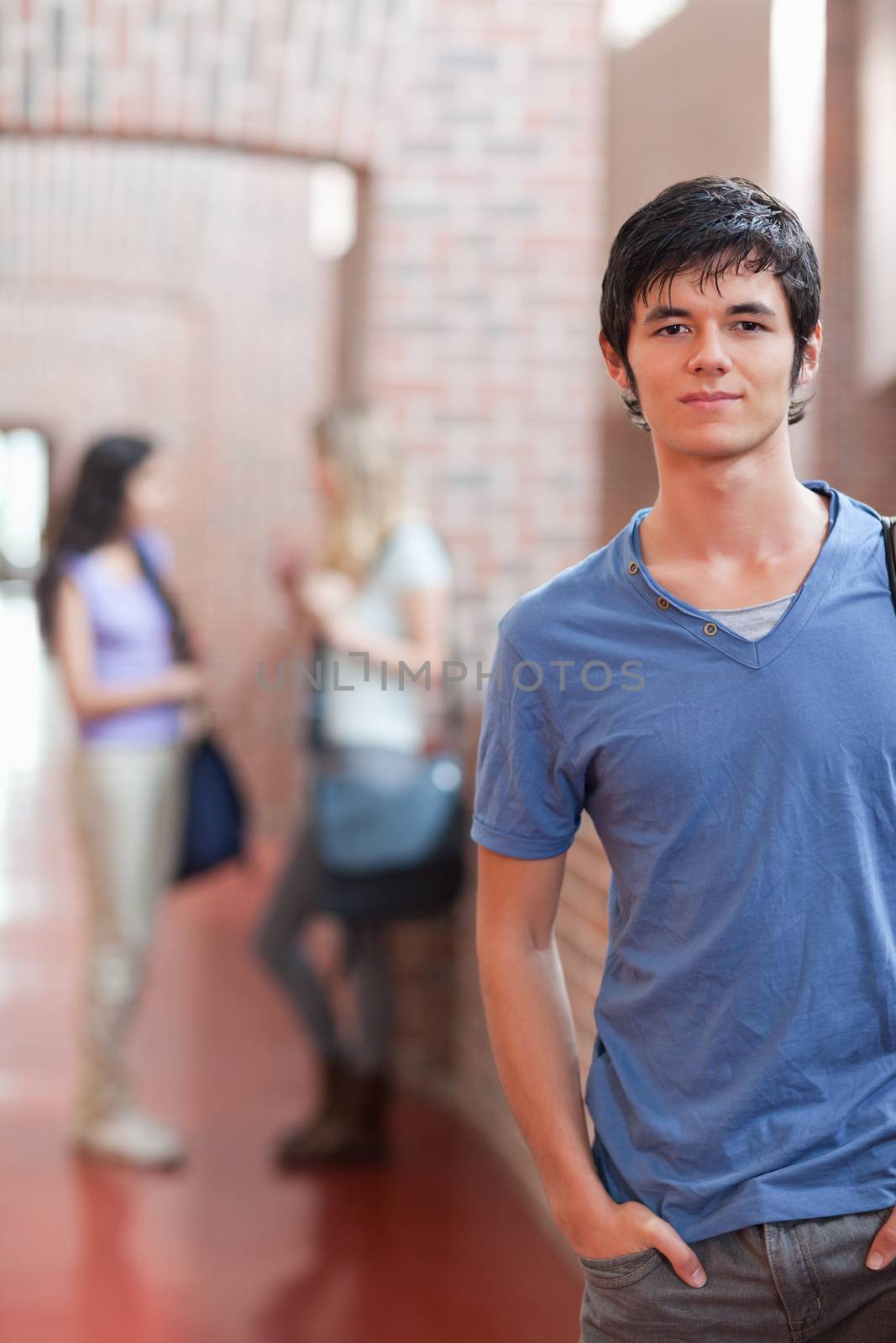 Portrait of a handsome student posing in a corridor