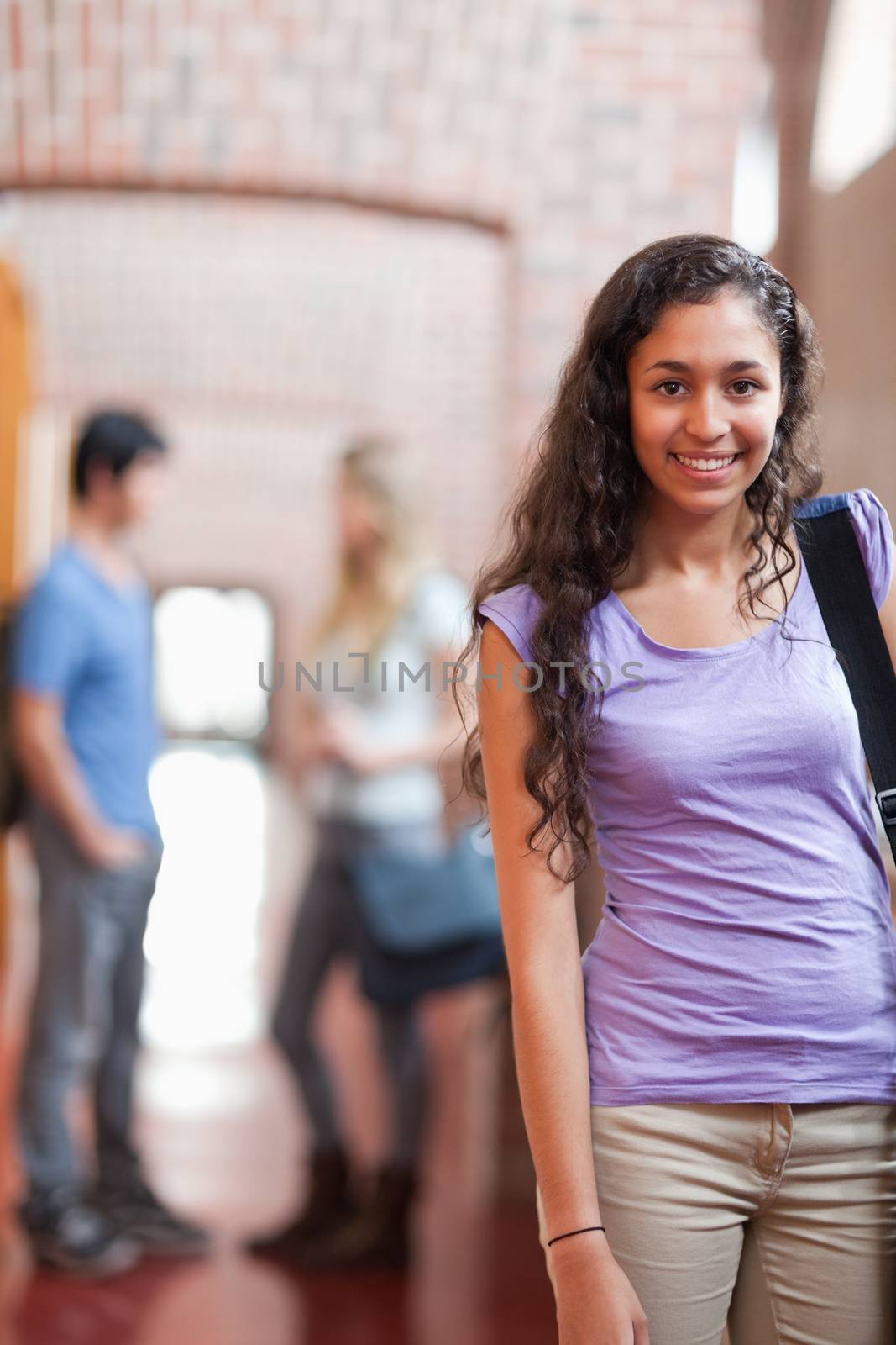 Portrait of a young student posing in a corridor