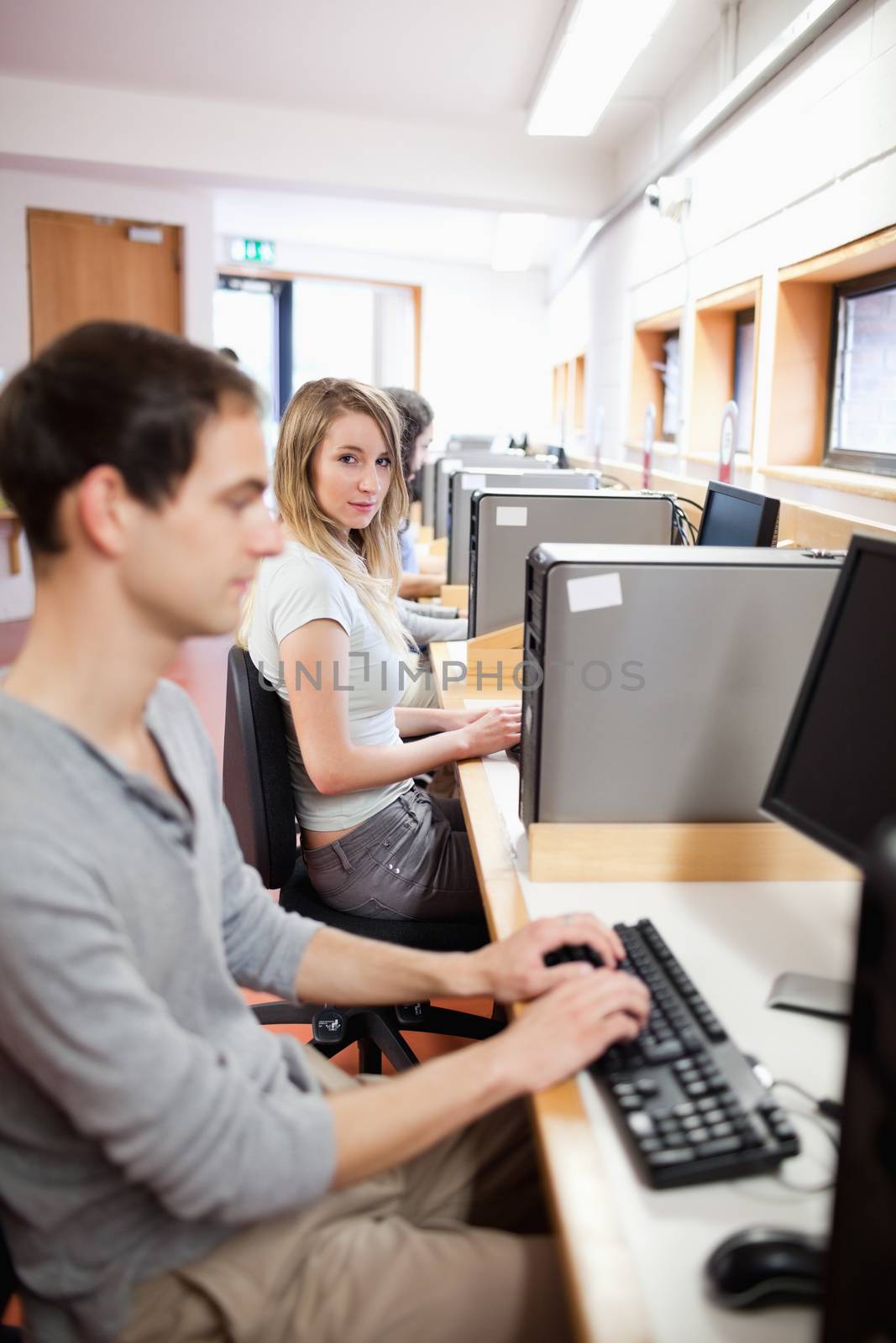 Portrait of a fellow students using a computer in an IT room