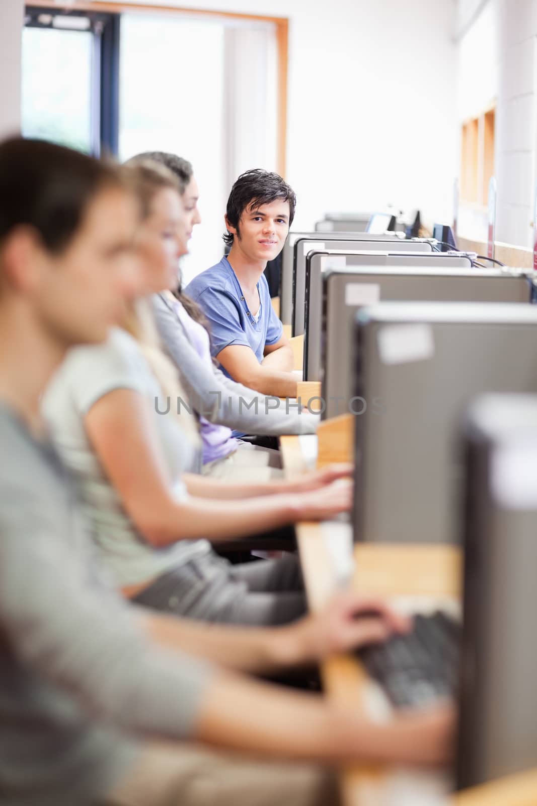 Portrait of young fellow students in an IT room by Wavebreakmedia