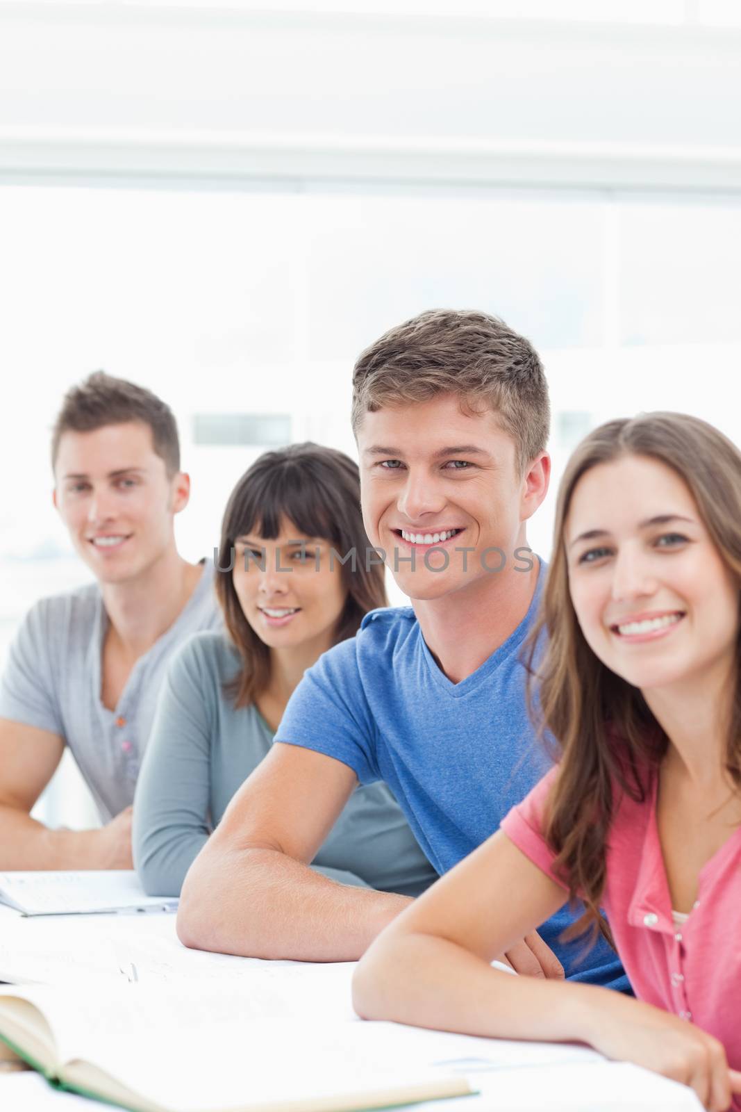 A group of brightly smiling people looking into the camera 