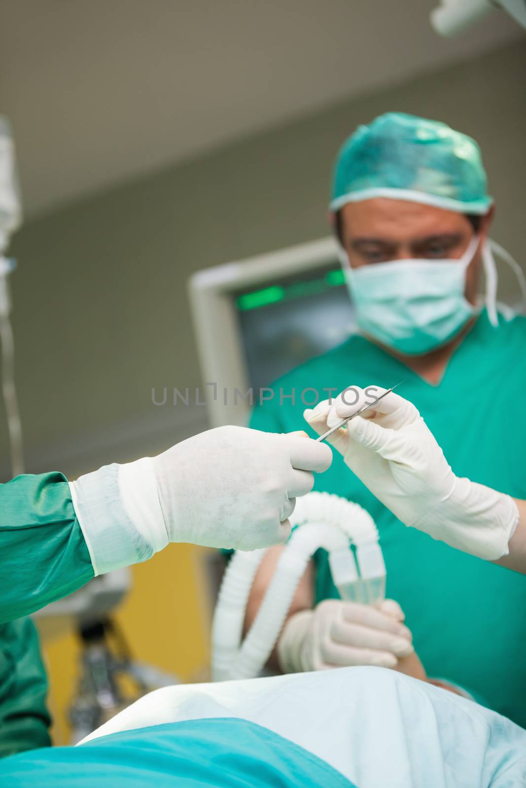 Surgeons holding a scalpel by Wavebreakmedia