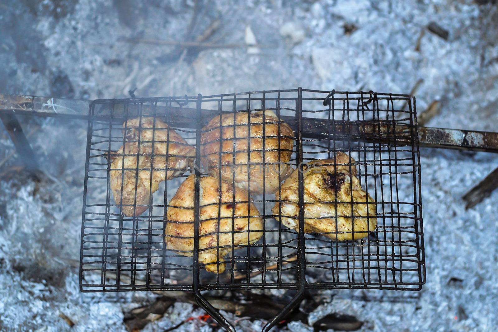 Barbeque from pork prepared outdoors on a hot summer day in a camp