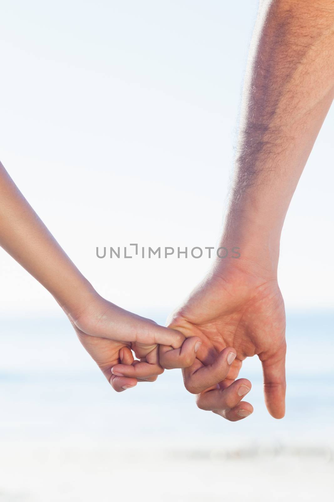 Loving young couple holding hands by Wavebreakmedia