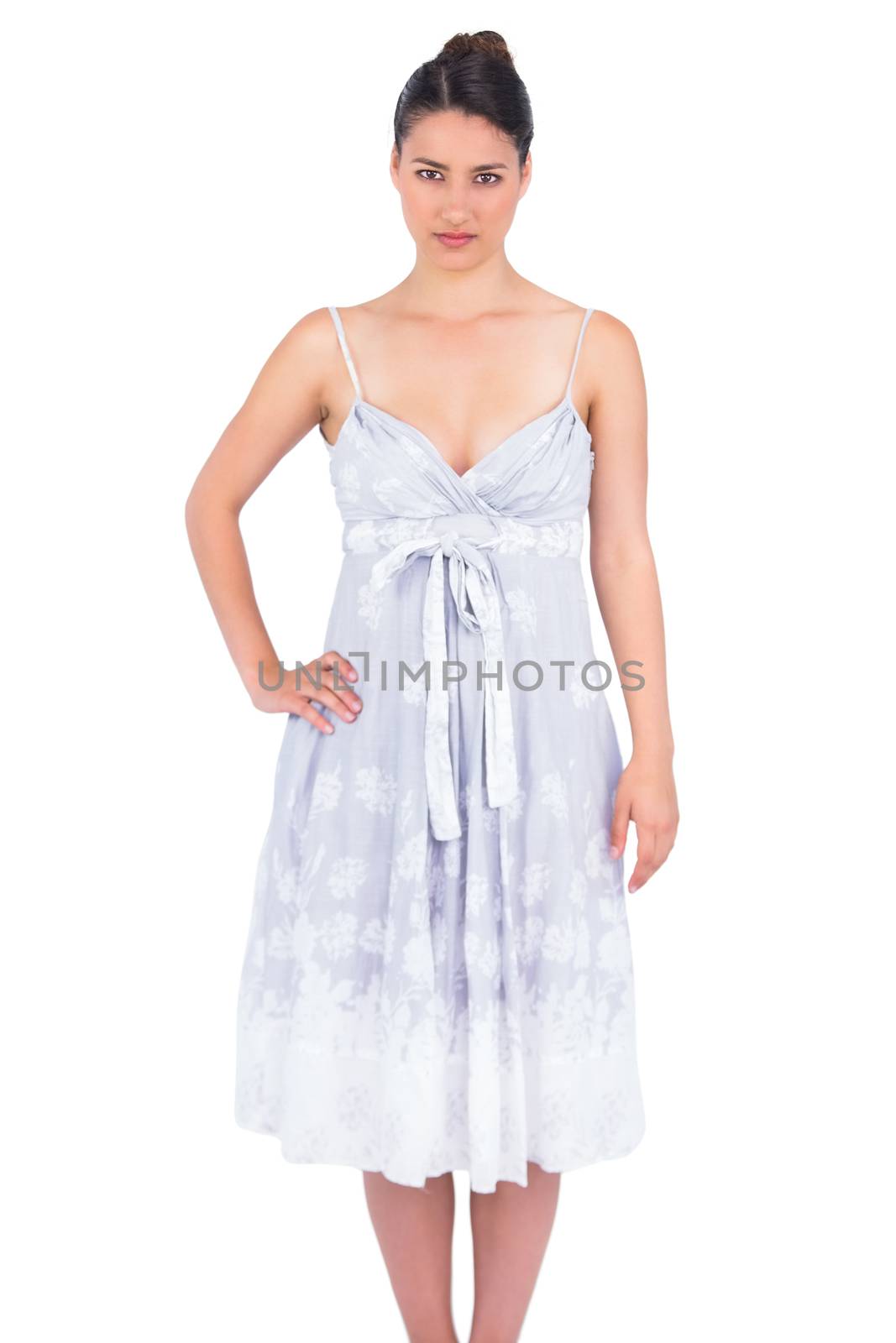 Serious seductive young model in summer dress posing by Wavebreakmedia