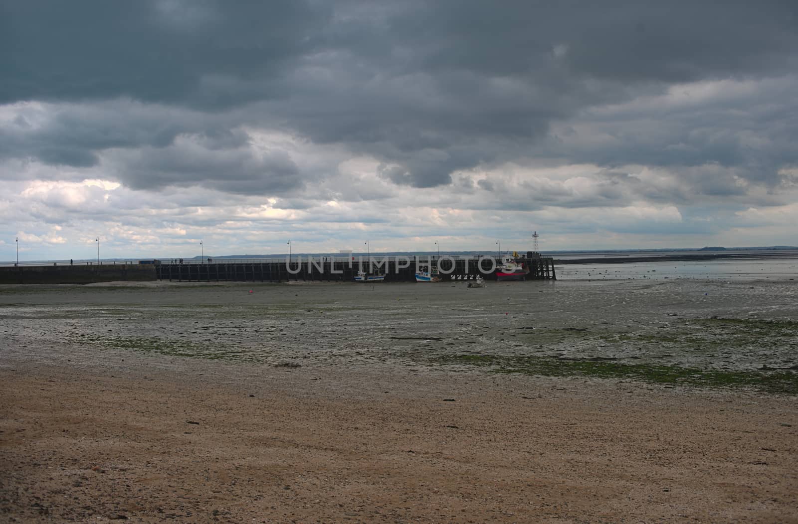 Atlantic ocean shore with pier for shipping boats at Cancale, France by sheriffkule