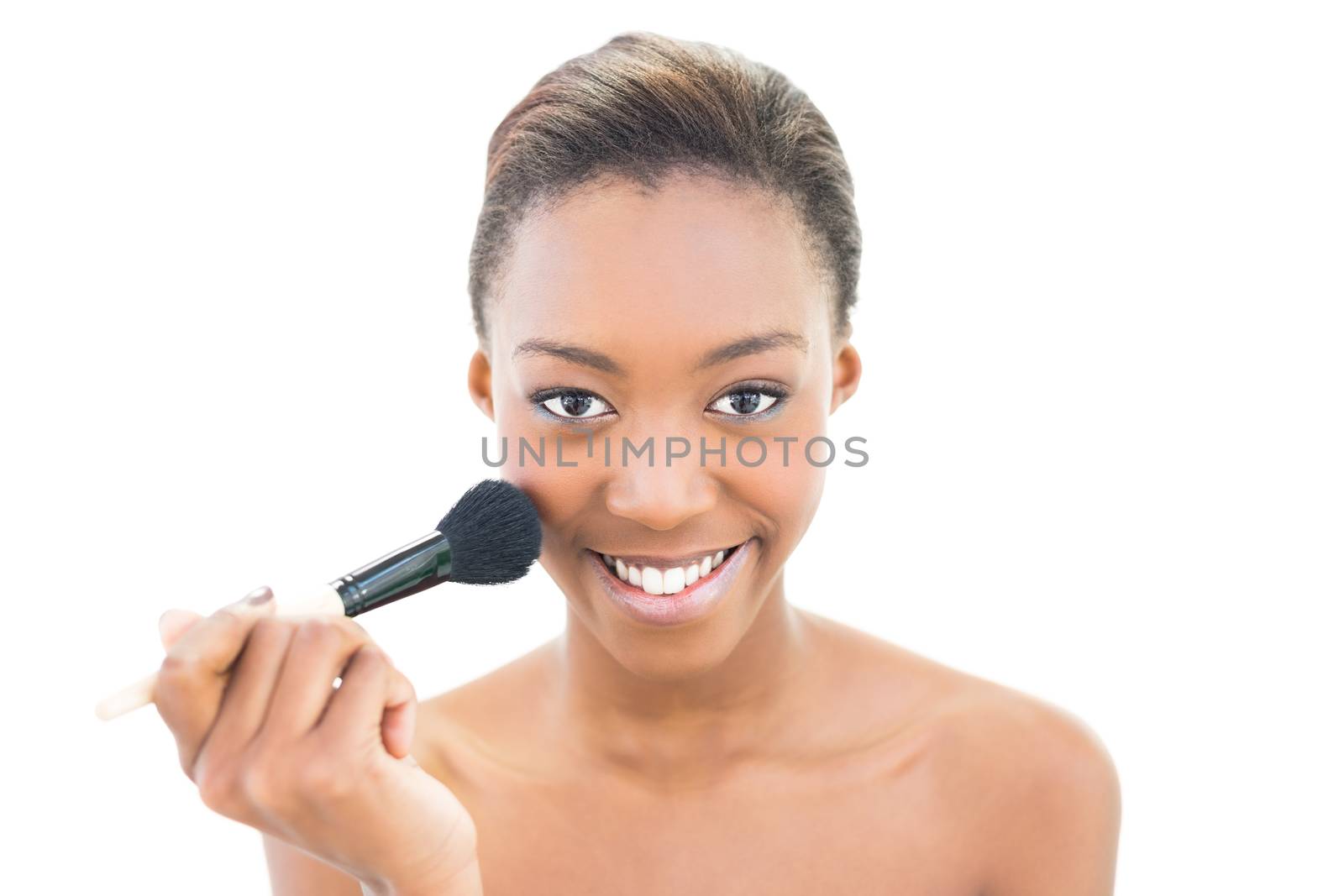 Smiling beauty applying makeup on white background