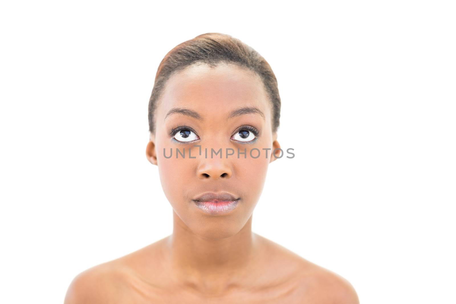 Portrait of natural nude beauty looking up on white background