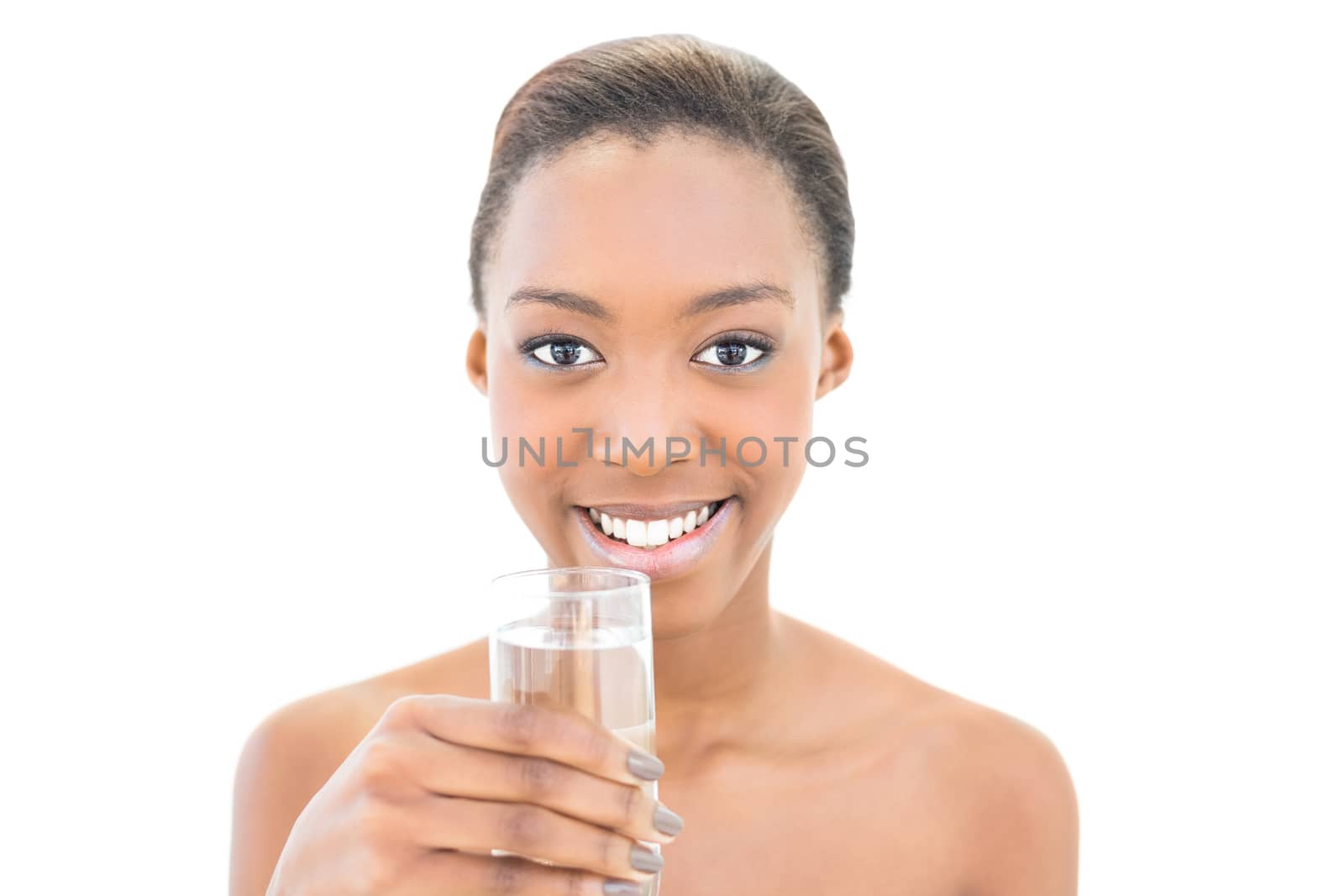 Smiling natural beauty holding water glass on white background