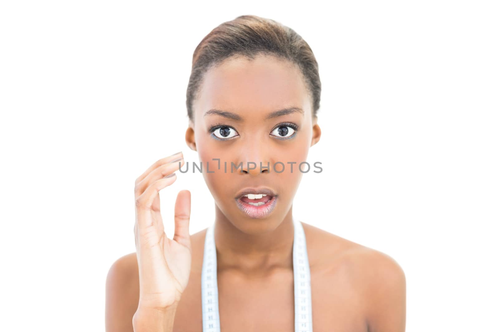 Surprised natural beauty with measuring tape over the neck on white background