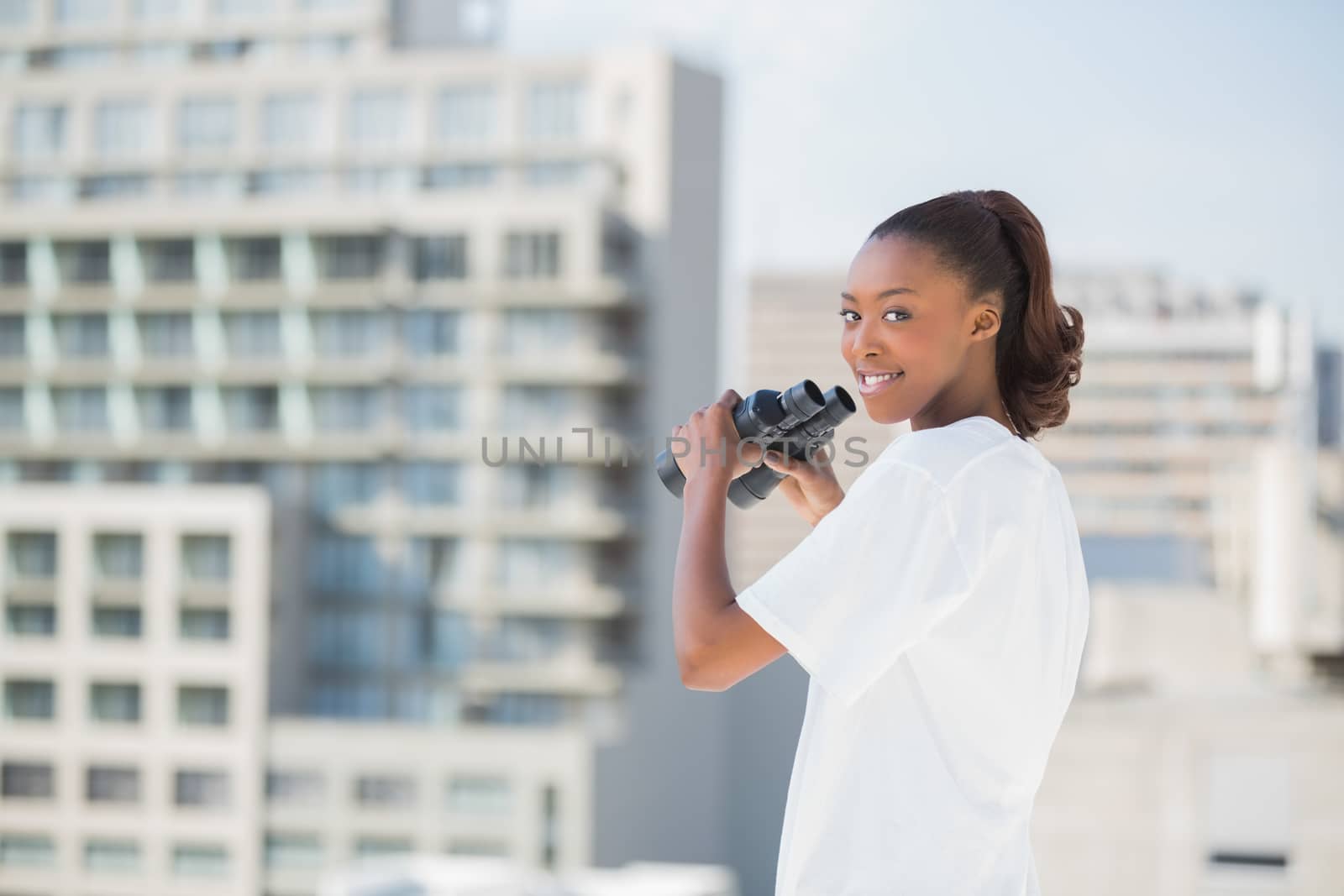 Woman with binoculars looking at camera by Wavebreakmedia