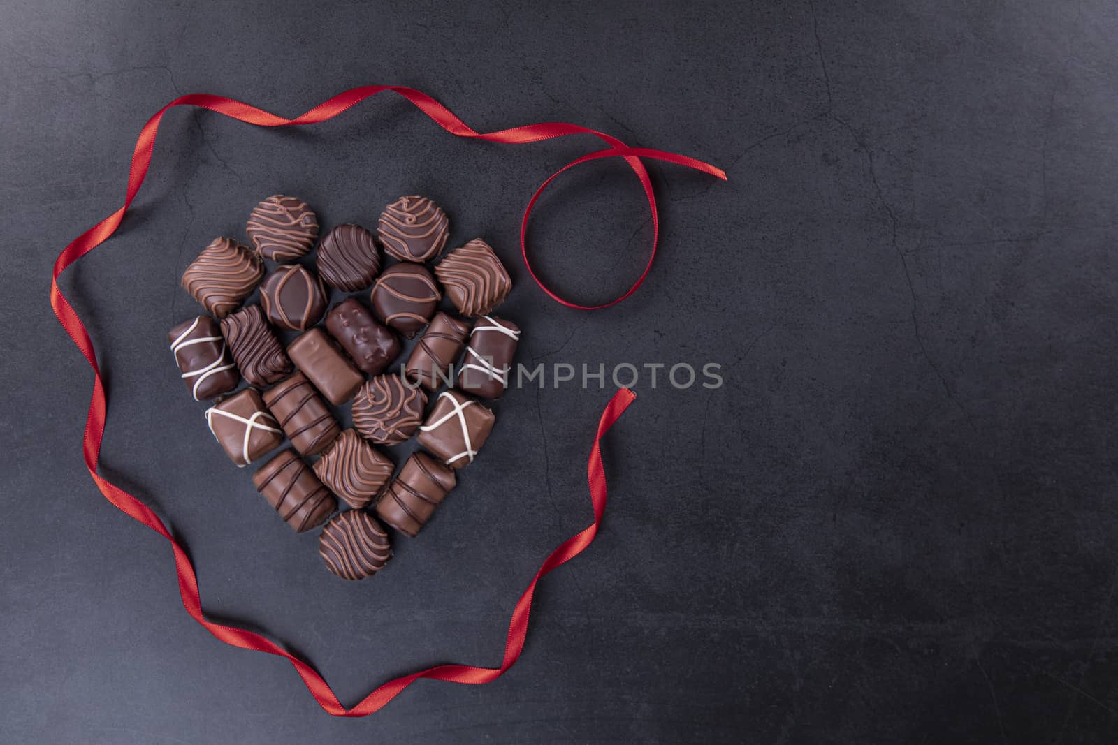Chocolate pralines  for Valentines day or Mothers day concept on black background