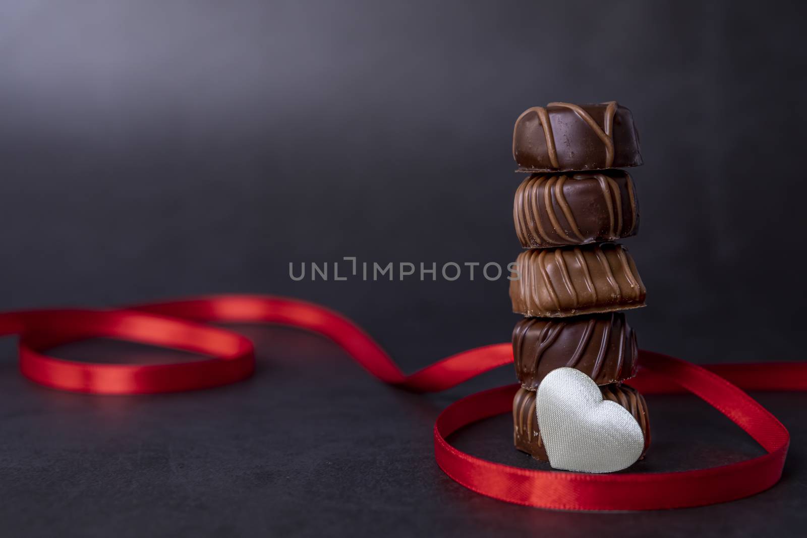 Stack of pralines chocolate for Valentines day by manaemedia