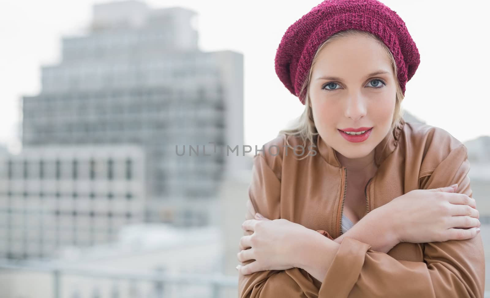 Cold casual blonde posing outdoors on urban background