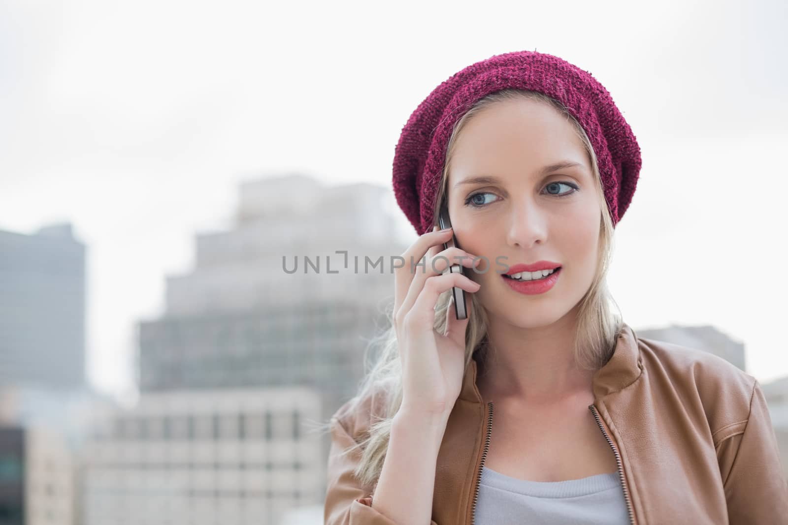 Focused casual blonde on the phone outdoors by Wavebreakmedia
