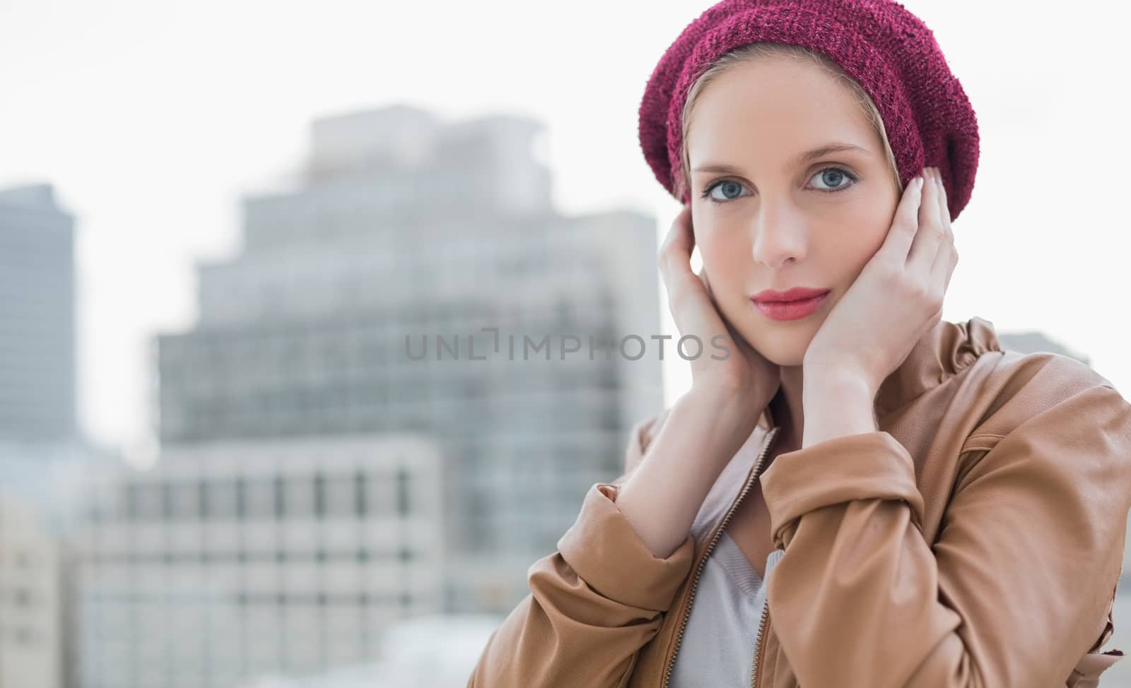 Peaceful casual blonde posing outdoors on urban background