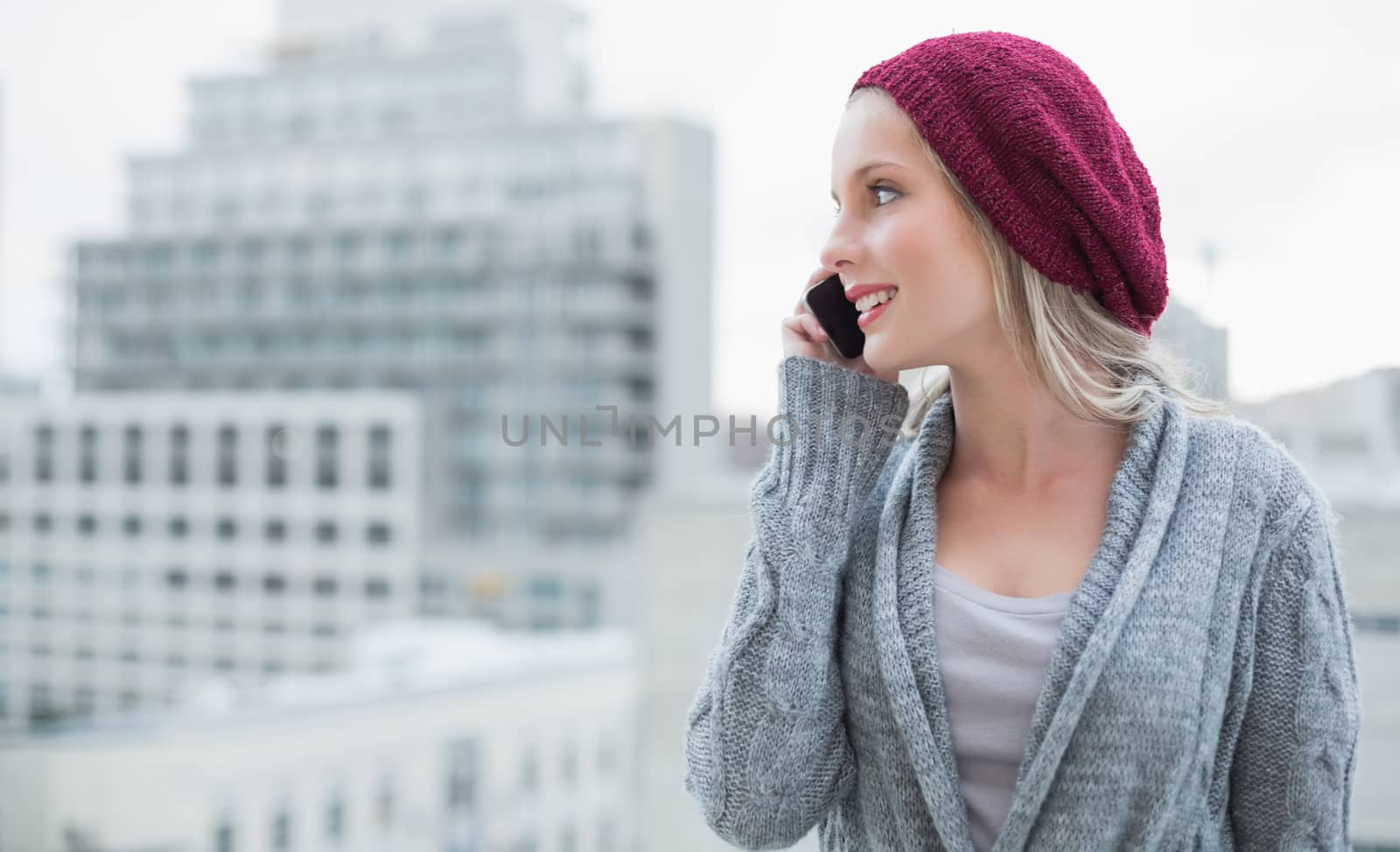 Happy pretty blonde on the phone outdoors by Wavebreakmedia