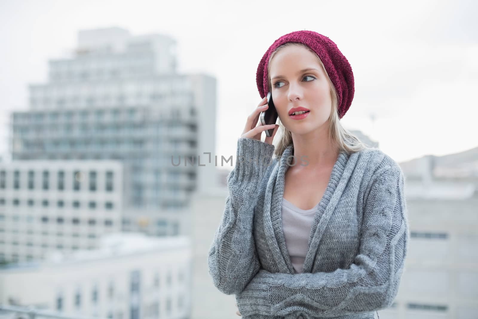 Serious pretty blonde on the phone outdoors by Wavebreakmedia