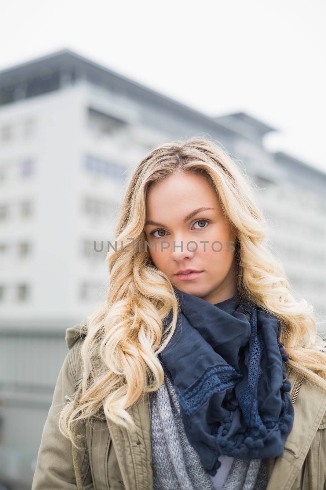 Unsmiling attractive blonde posing outdoors by Wavebreakmedia