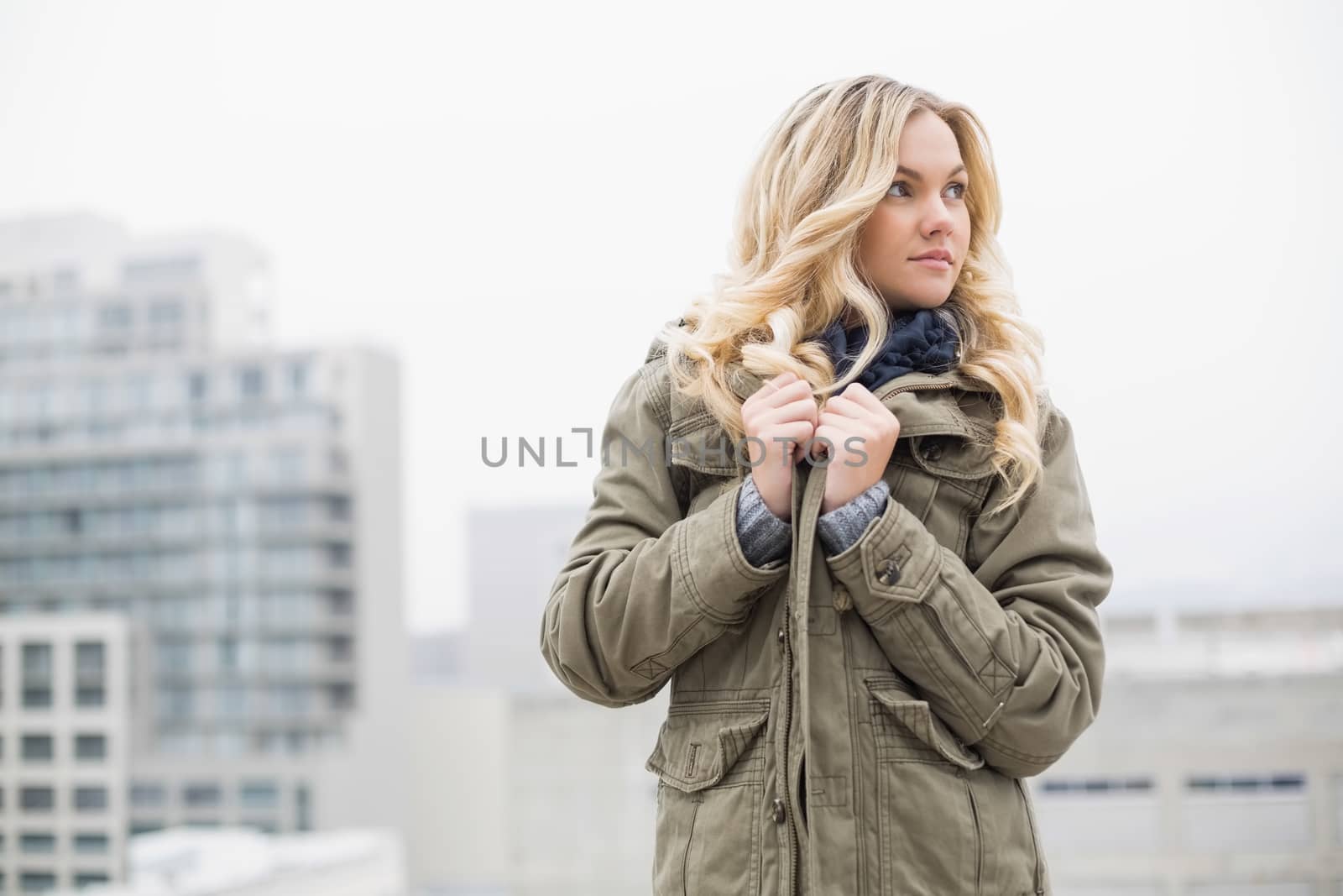 Gorgeous trendy blonde posing outdoors on urban background