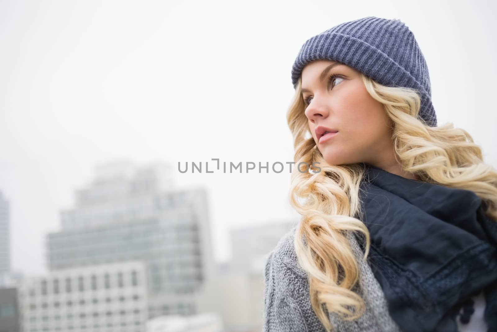 Thoughtful gorgeous blonde posing outdoors by Wavebreakmedia