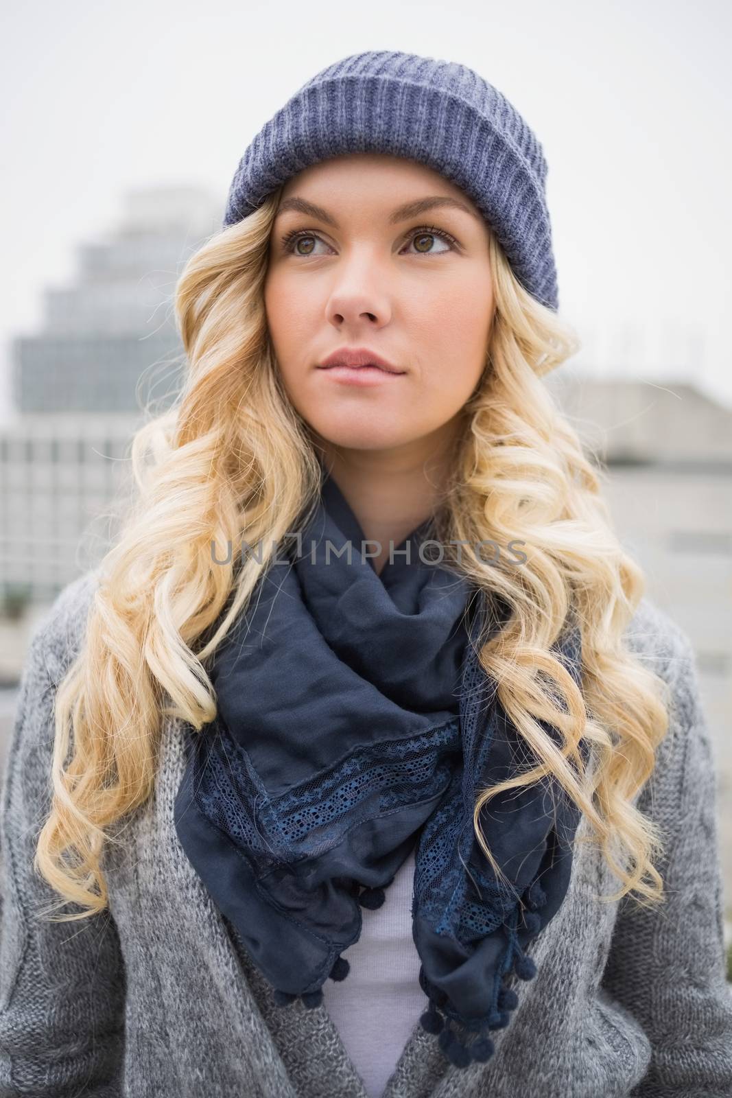 Thoughtful pretty blonde posing outdoors by Wavebreakmedia