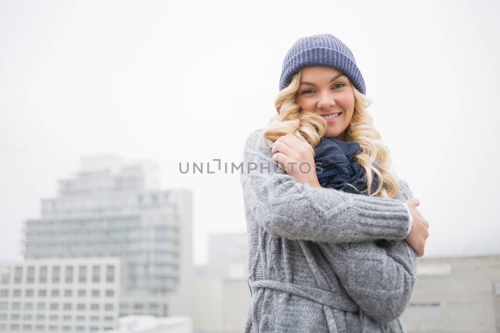 Smiling gorgeous blonde posing outdoors by Wavebreakmedia