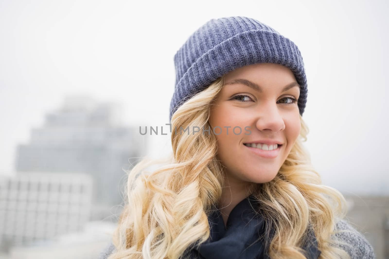Smiling attractive blonde posing outdoors by Wavebreakmedia