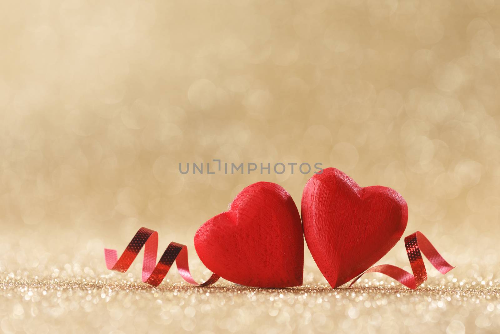 Two red wooden hearts symbol of love on background with beautiful bokeh, Saint Valentine Day celebration, copy space for text