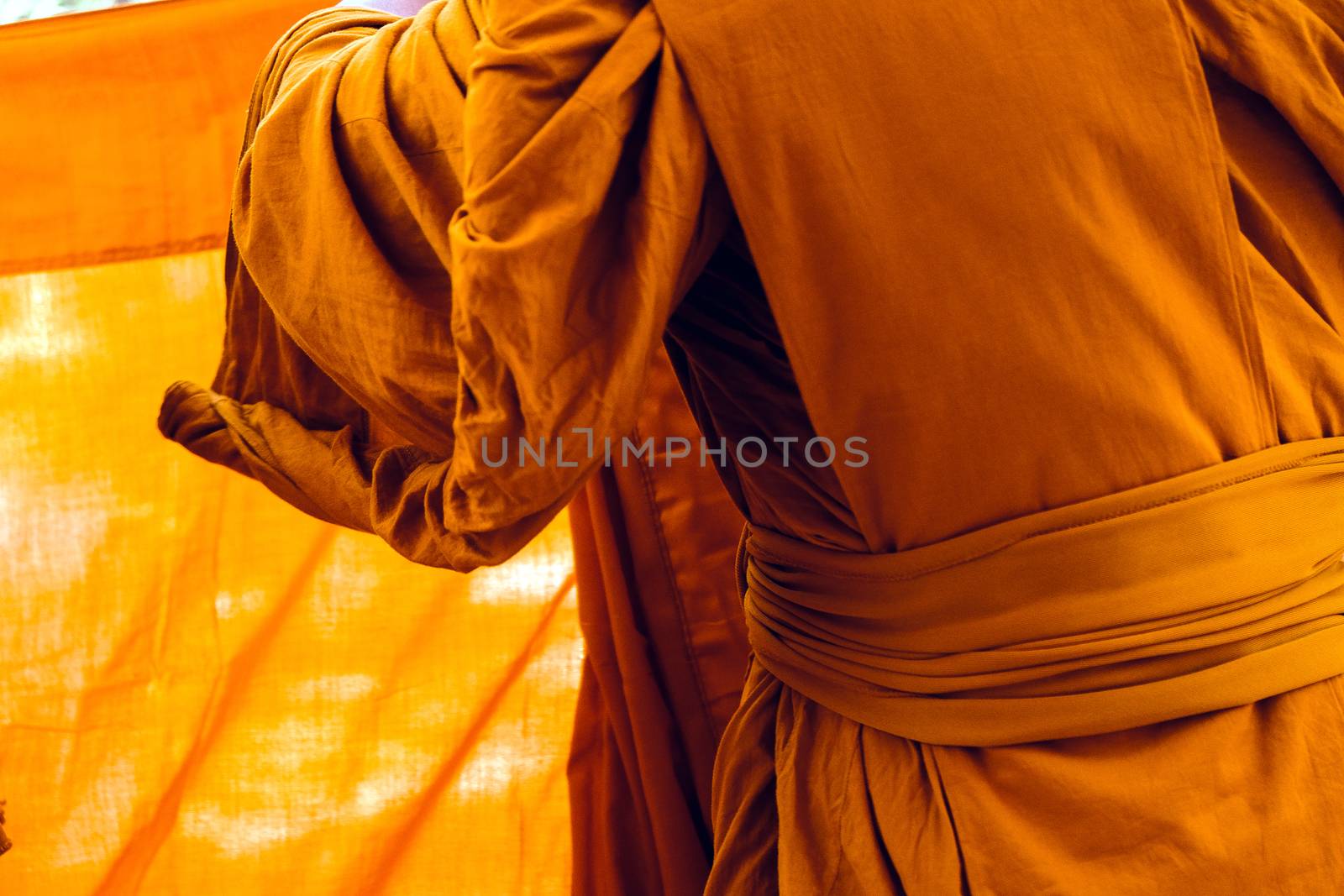 Yellow robe of Buddhist monks, Closeup on buddhist monk