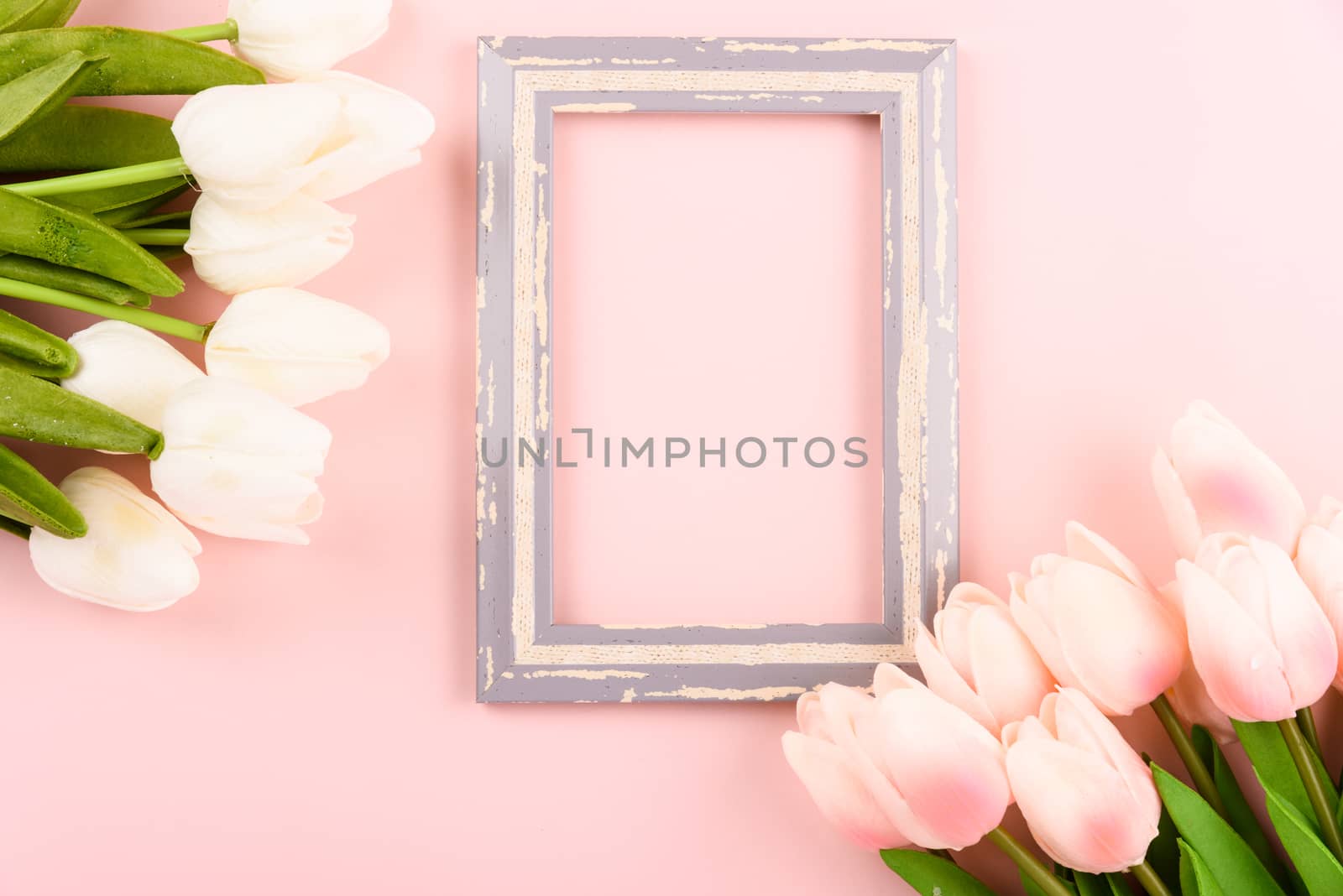 Happy Women's Day, Mother's Day concept. top view flat lay photo frame and Tulip flower on pink background, copy space for your text