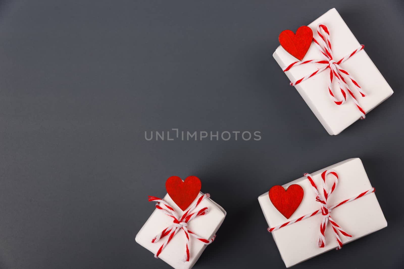 Valentine's day Concept, flat lay top view, White Gift Box and Red Heart on Gray background with copy space for your text