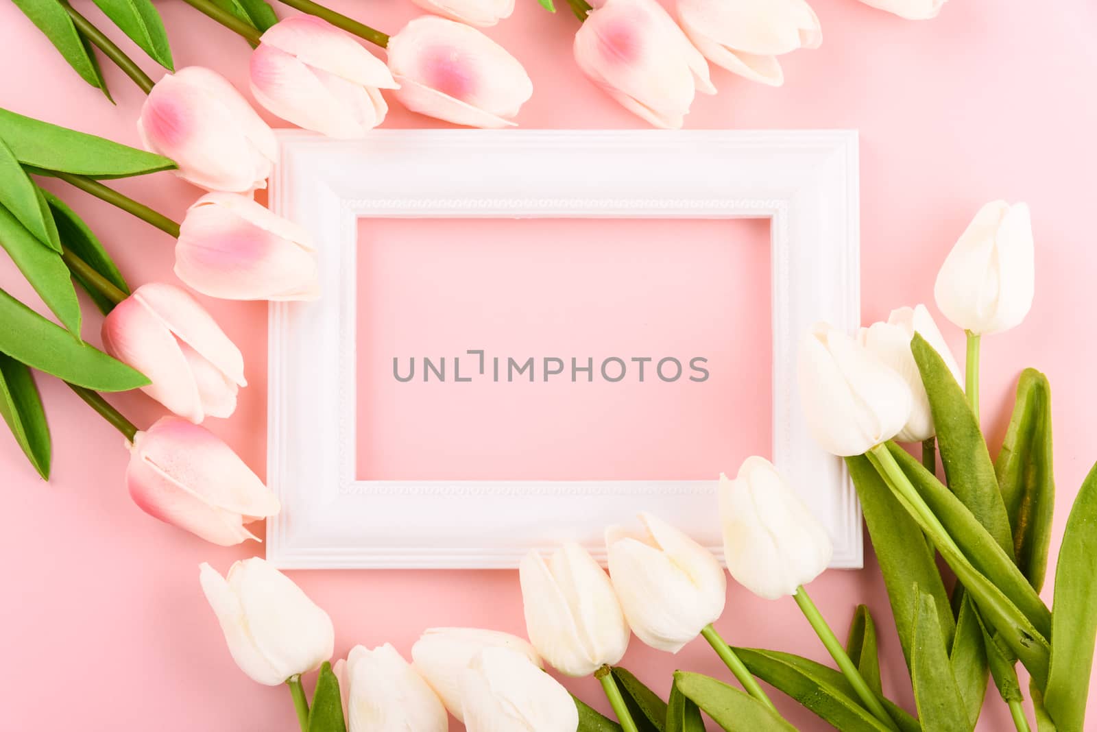 Happy Women's Day, Mother's Day concept. top view flat lay Tulip flower and photo frame on pink background, copy space for your text