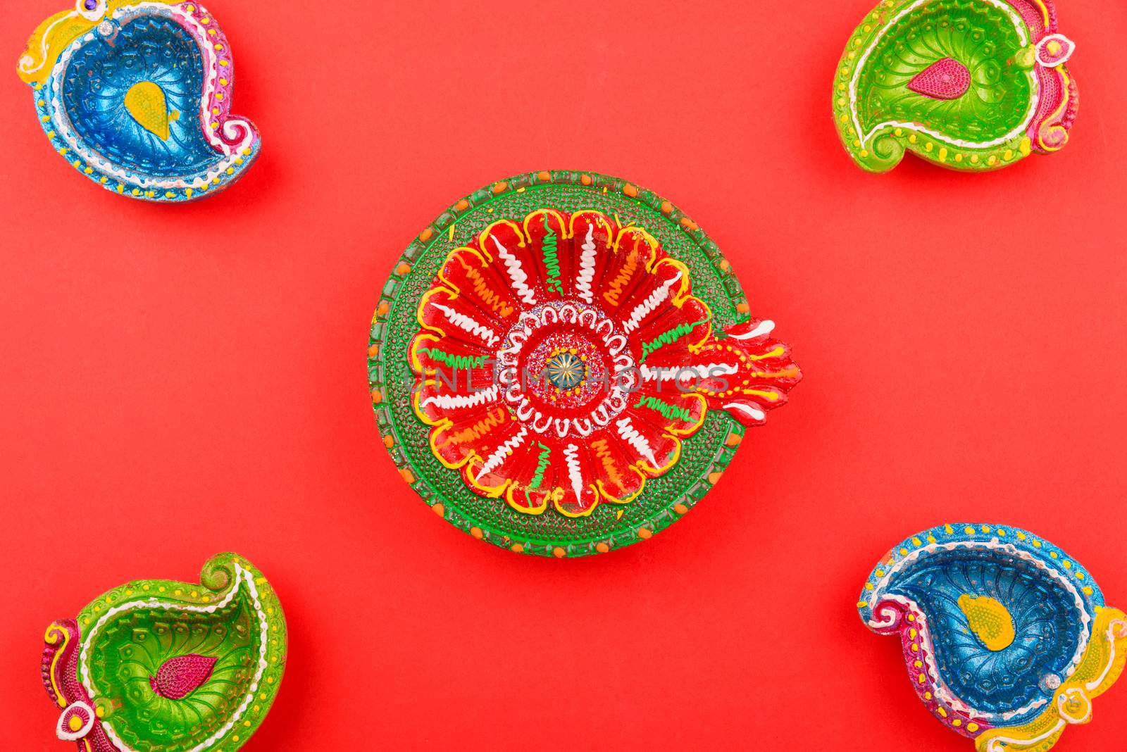 Happy Diwali Day, Flat lay top view Colorful Clay Diya lamps on red background and copy space for your text