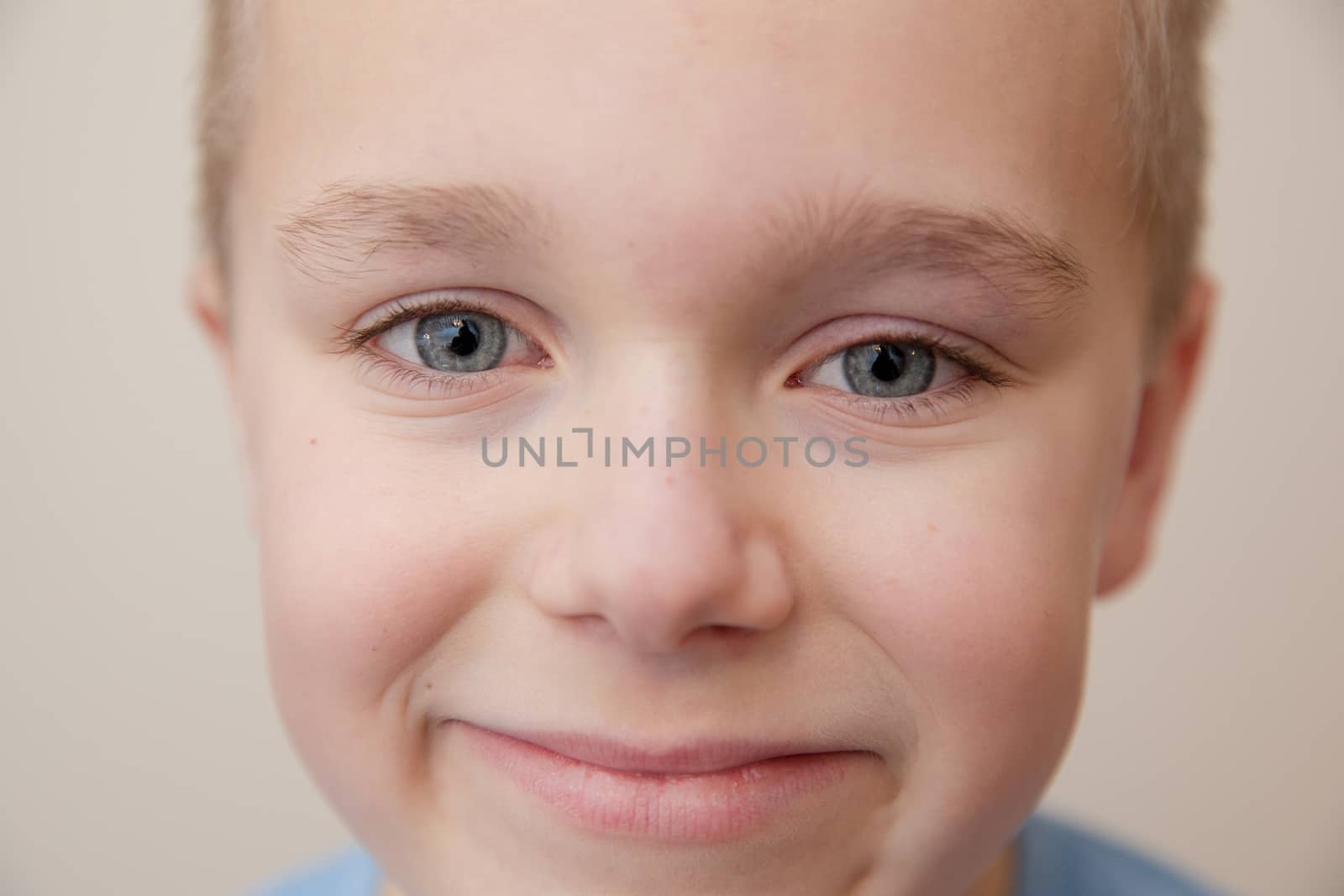 close up of a young boy giving a calm smile
