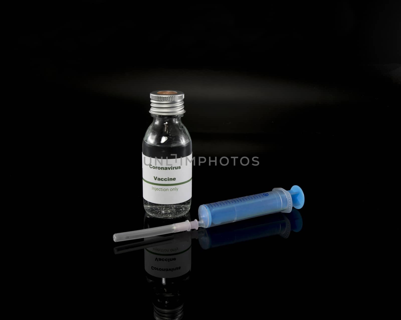 Coronavirus vaccine vial with injection syringe isolated on black background