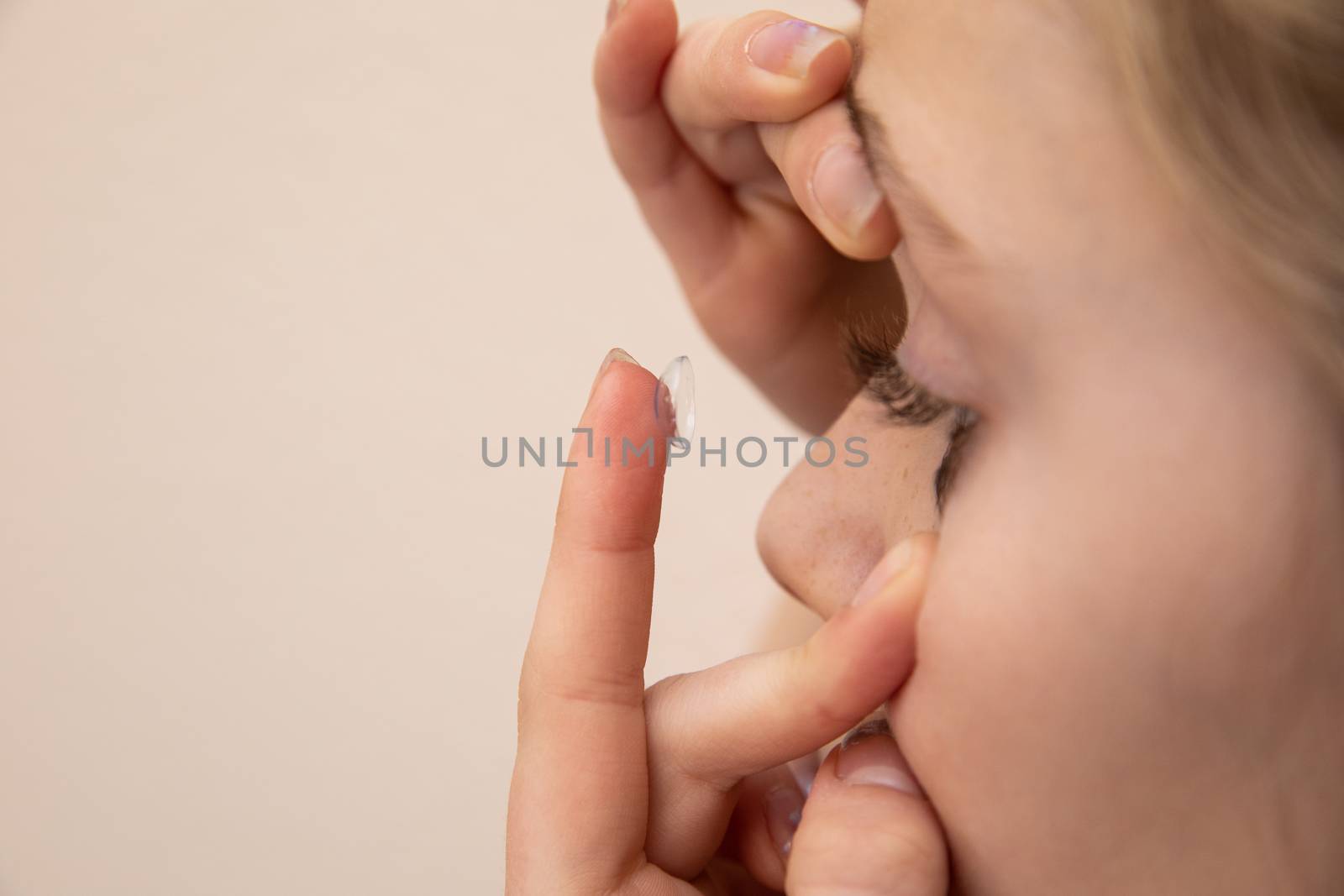 Young girl who is wearing contact lenses and getting ready to put them in.