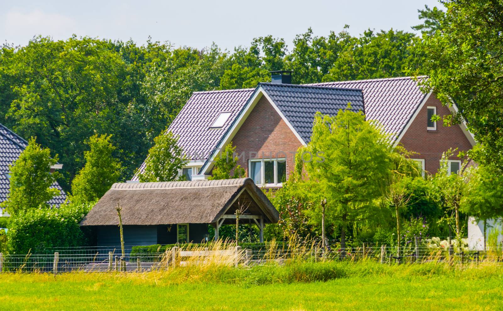 Modern farm house with a big grass pasture, Dutch architecture at the country side, Bergen op zoom, The Netherlands