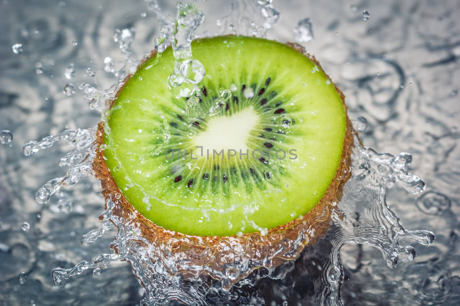 Kiwi fruit water splash - Concept of fresh tasty healthy fruit. Water falling on half of a kiwi. by petrsvoboda91